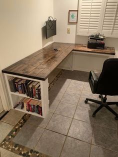 an office with a desk, chair and bookshelf on the floor in front of it