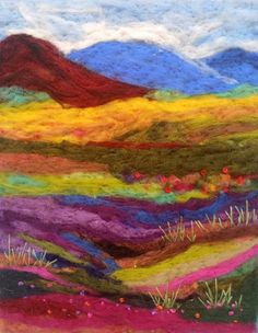 a multicolored piece of yarn with mountains in the background