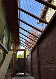 an alley way with a glass roof and brick walls