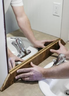 a man with his hands on the edge of a sink