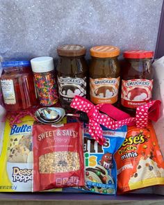 an open suitcase filled with snacks and condiments