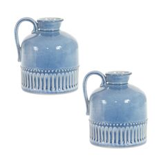 two blue vases sitting next to each other