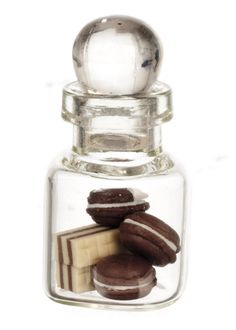 a glass bottle filled with different types of cookies