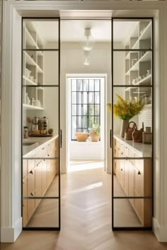 an open door leading to a kitchen with lots of counter tops and cabinets in it