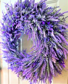 a purple wreath hanging on the front door