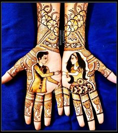 two hands with henna designs on them