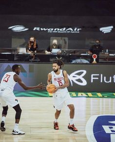 two basketball players in action on the court