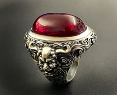 RING PROFILE: 🔱 Indulge in the allure of the 'Devil's Blood Ring,' a captivating piece that embodies the mystique of dark elegance. Crafted with precision and imbued with a touch of the infernal, this ring is a mesmerizing fusion of sophistication and edge. The deep, crimson hues evoke a sense of forbidden passion, while the intricate design channels the essence of the occult. Elevate your style with this unique accessory that beckons the daring and those drawn to the darker realms. The Devil's Blood Rings, Blood Ring, Blood Ruby, Dark Elegance, Exotic Jewelry, Tarnish Remover, Large Ring, Bespoke Jewellery, Engraved Jewelry