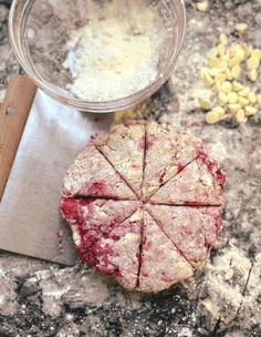 a piece of food sitting on top of a counter next to a knife and bowl