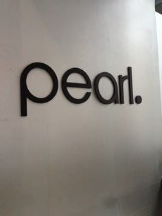 a sign that says peal on the side of a wall in an office building