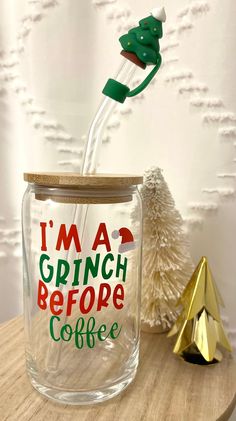 a glass jar filled with liquid sitting on top of a table next to a christmas tree