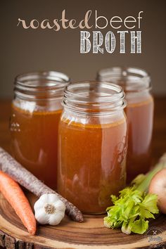 three jars filled with food sitting on top of a wooden table