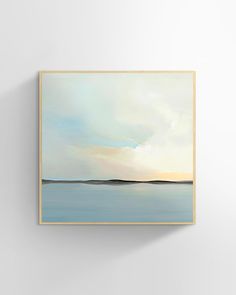 a painting hanging on the wall next to a white wall with a blue ocean scene