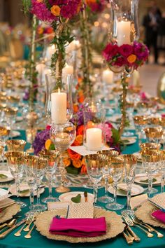 an image of a table setting with candles and place settings on the table for dinner