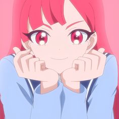 a girl with red hair and big eyes is looking at the camera while holding her hands to her face