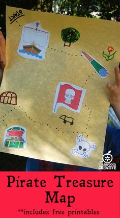 a child holding up a pirate map with stickers on it