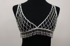 a black mannequin with silver beads on it's neck and an open back