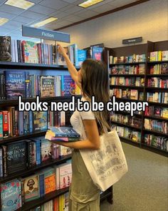 a girl is standing in front of a bookshelf and pointing at the book to be cheaper