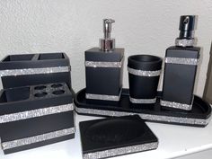 black and silver bathroom accessories on a white counter