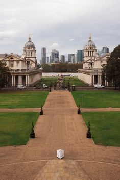 an empty walkway in front of some very large buildings