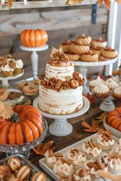 a table topped with lots of cakes and desserts