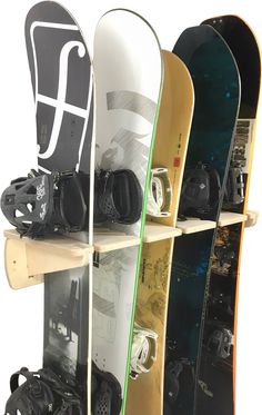 several snowboards are lined up on wooden shelves