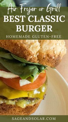 a close up of a sandwich with lettuce and tomato on it in front of the words, air fryer or grill best classic burger homemade gluten - free