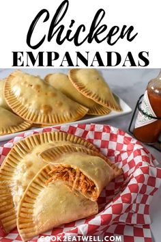 chicken empanadas on a red and white checkered plate