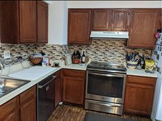 a kitchen with wooden cabinets and stainless steel appliances