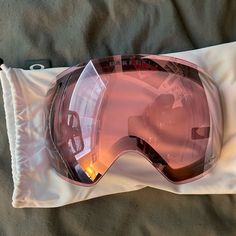 a pair of ski goggles laying on top of a pillow