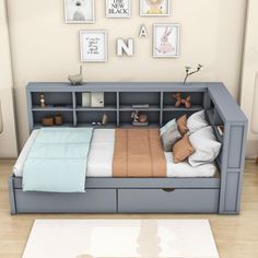 a bedroom with a bed, dresser and pictures on the wall