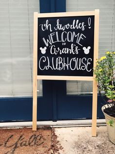 a welcome sign in front of a blue door