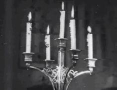 a large metal candelabra with many lit candles