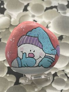 a painted rock with a snowman on it