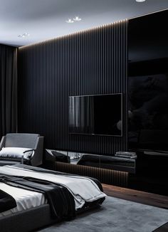 a modern bedroom with black walls and white bedding, large television on the wall