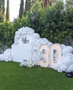 an image of a 50th birthday party setting with balloons and lights in the shape of letters