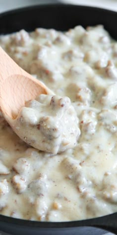 the best sausage gravy in a skillet with a wooden spoon