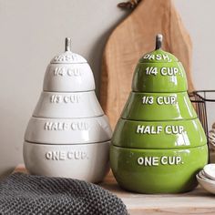 three ceramic pears are stacked on top of each other with words written on them