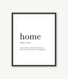 a framed black and white poster with the words home in cursive font on it