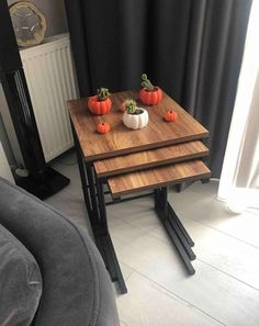 three small wooden trays with succulent plants on them