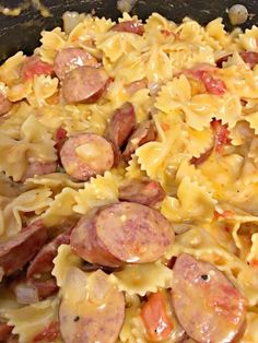 a pan filled with pasta and sausage on top of it