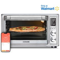 an appliance with a pizza in the oven next to it and a cell phone