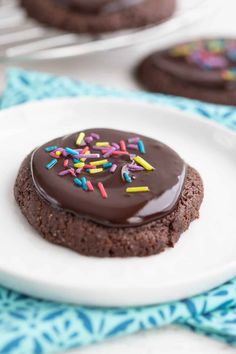 chocolate cookies with sprinkles on a white plate