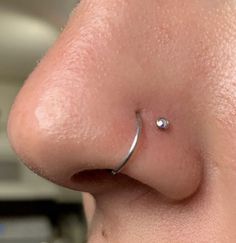 a nose piercing is seen in this image