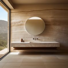 a bathroom with a large mirror above it and a sink in front of a window