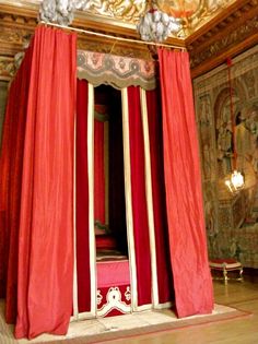 an elaborately decorated room with red drapes