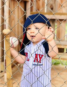 a little boy that is holding a baseball bat