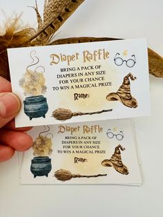 two harry potter business cards being held by someone