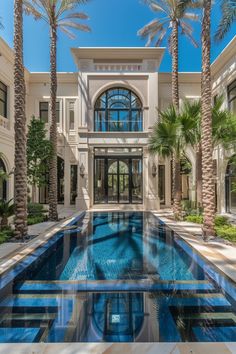 the pool is surrounded by palm trees and glass doors