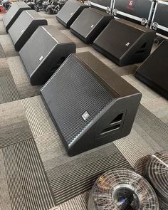 there are many speakers lined up on the floor